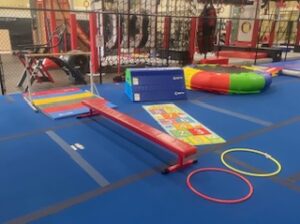 A gym with some obstacles and toys on the floor