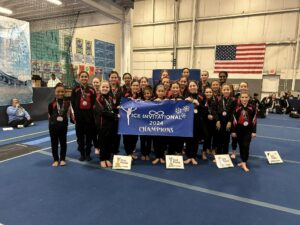 A group of young girls holding up their medals.